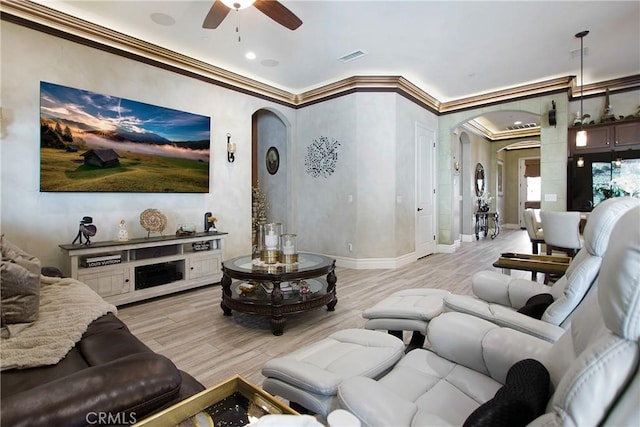 living room with ceiling fan, crown molding, and light hardwood / wood-style flooring