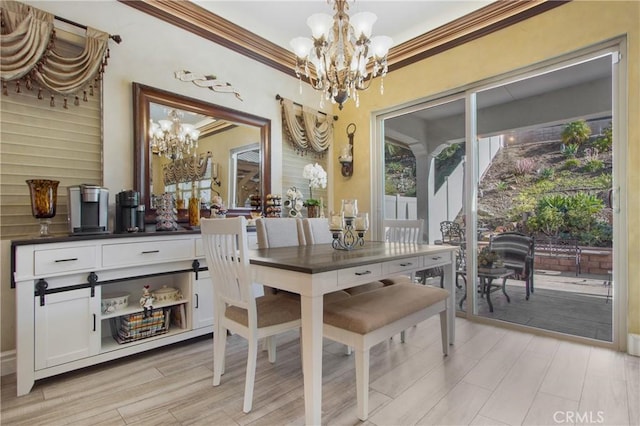 dining area with a notable chandelier and crown molding