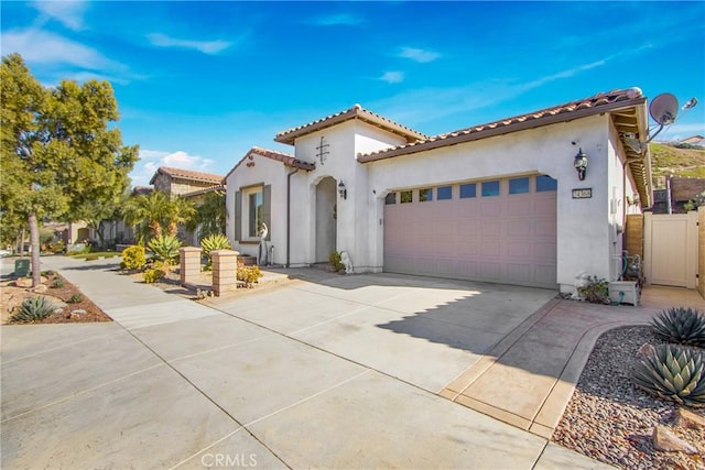 mediterranean / spanish home featuring a garage