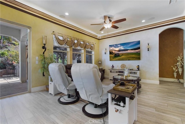 living room featuring ceiling fan and crown molding