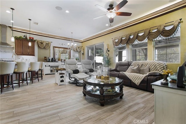 living room featuring crown molding and ceiling fan with notable chandelier