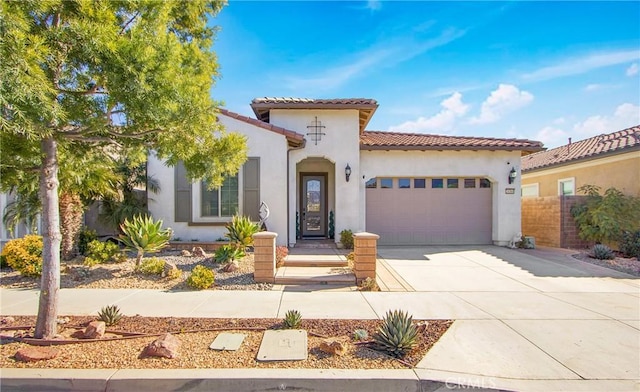 mediterranean / spanish-style home with a garage