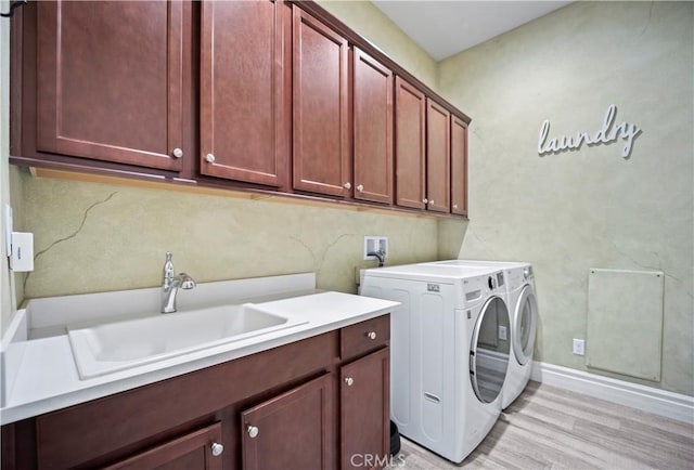 24368 Overlook Dr, Corona, CA 92883 - clothes washing area with a sink, cabinet space, separate washer and dryer, and light wood-type flooring