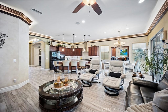 24368 Overlook Dr, Corona, CA 92883 - living area with light wood-style flooring, visible vents, ornamental molding, arched walkways, and ceiling fan with notable chandelier