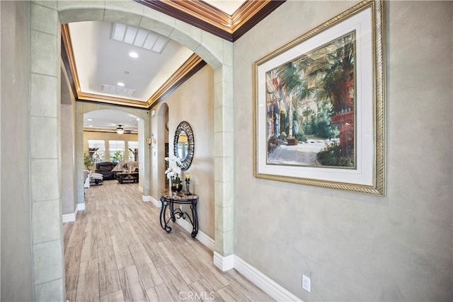 24368 Overlook Dr, Corona, CA 92883 - hall featuring ornamental molding, baseboards, arched walkways, visible vents, and wood finished floors