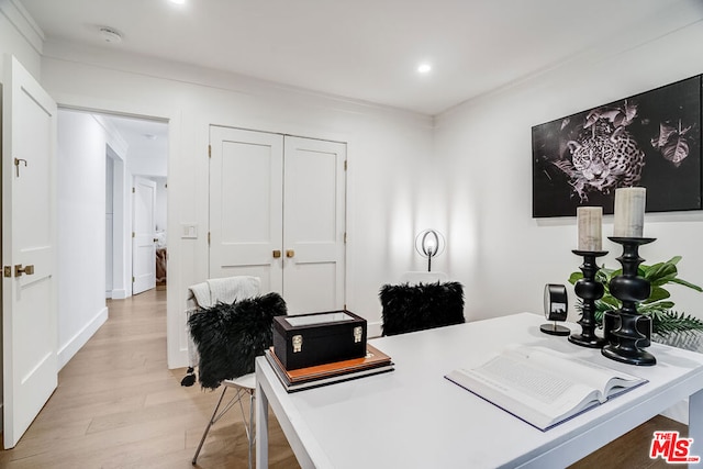 home office with light hardwood / wood-style flooring