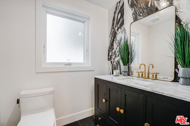 bathroom with vanity, tile patterned floors, and toilet