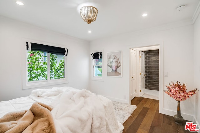 bedroom featuring ornamental molding and dark hardwood / wood-style flooring