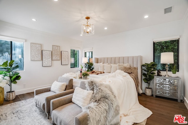 bedroom with crown molding, dark wood-type flooring, and a chandelier