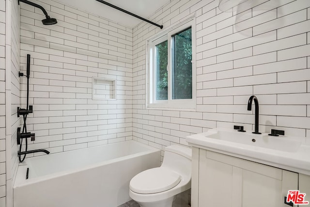 full bathroom featuring tasteful backsplash, tile walls, tiled shower / bath combo, vanity, and toilet