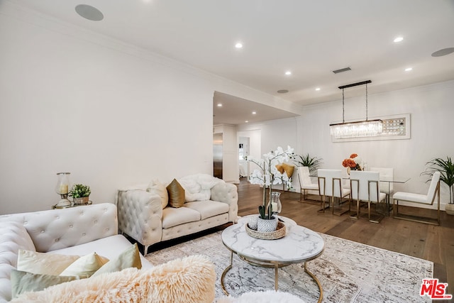 living room featuring ornamental molding and hardwood / wood-style floors