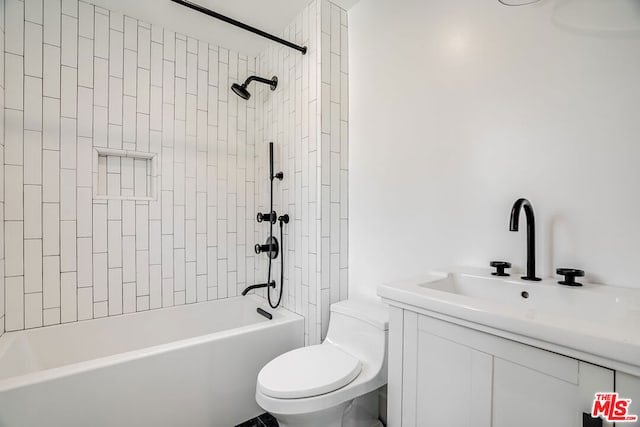 full bathroom featuring vanity, toilet, and tiled shower / bath combo