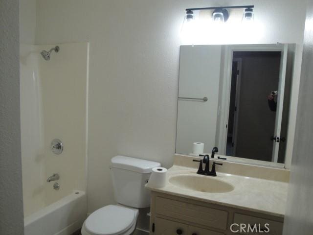 full bathroom featuring toilet, vanity, and bathing tub / shower combination