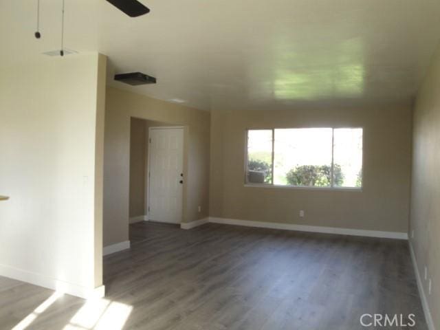 unfurnished room with dark wood-type flooring