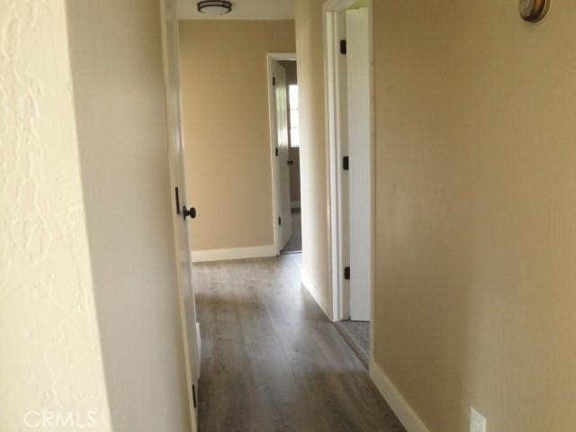 hallway with wood-type flooring