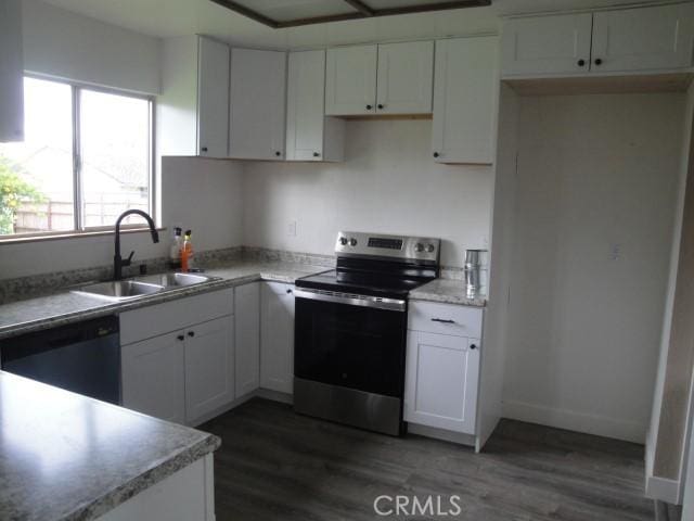 kitchen with white cabinetry, dark hardwood / wood-style flooring, dishwasher, stainless steel electric range, and sink