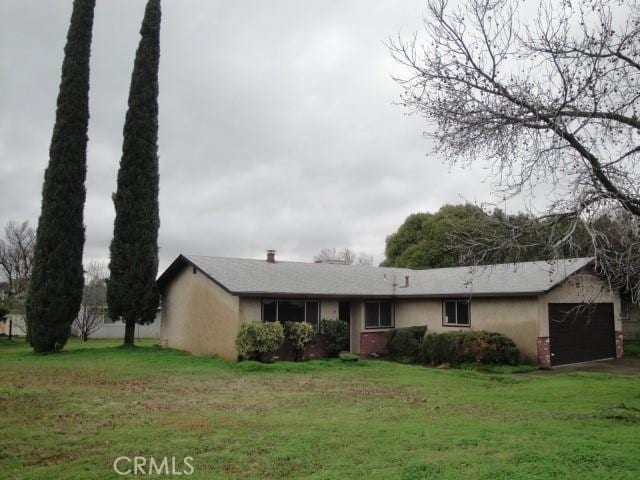 single story home with a front lawn and a garage