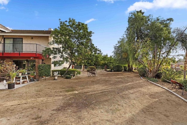 view of yard featuring a balcony