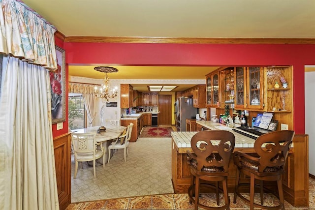 dining space featuring an inviting chandelier and ornamental molding