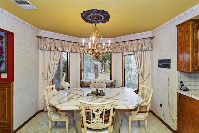 dining space with an inviting chandelier