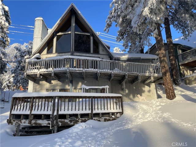 view of snow covered rear of property