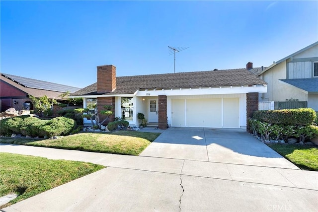 single story home with a front lawn and a garage