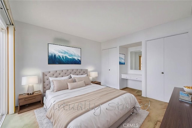 bedroom with light colored carpet and multiple closets