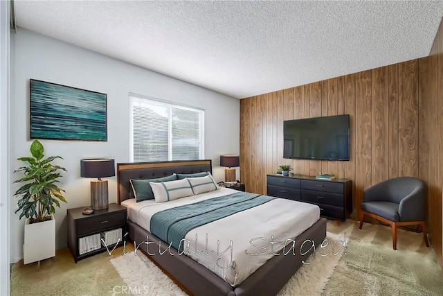 bedroom featuring a textured ceiling, light carpet, and wooden walls