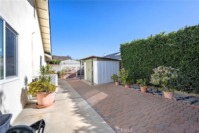 view of patio with a gazebo and a storage unit