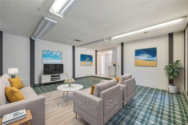 living room with wood-type flooring and a textured ceiling