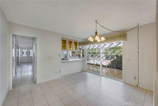 unfurnished dining area with a textured ceiling, an inviting chandelier, and light tile patterned floors