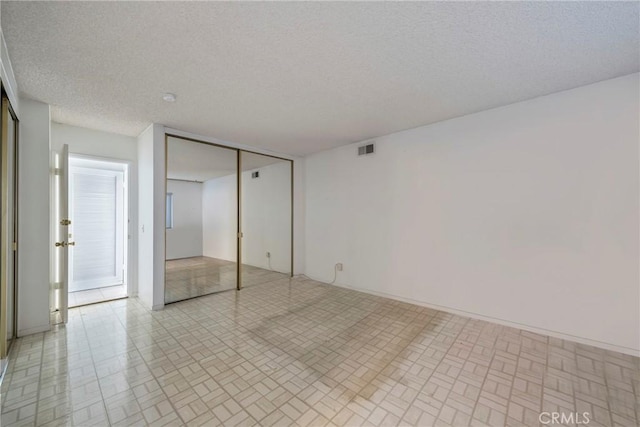 interior space featuring a textured ceiling and a closet