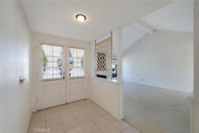 doorway to outside with light colored carpet, a textured ceiling, french doors, and vaulted ceiling with beams