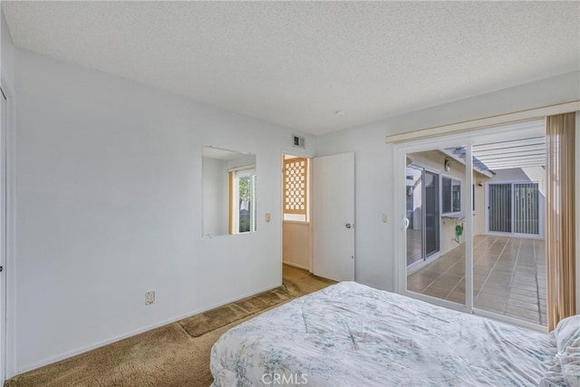 carpeted bedroom featuring a textured ceiling