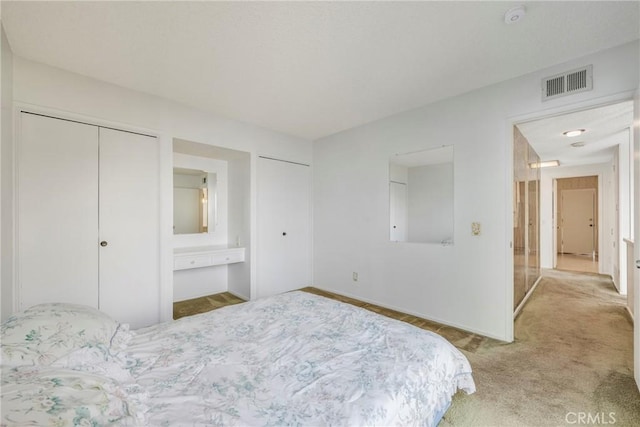 carpeted bedroom with ensuite bath