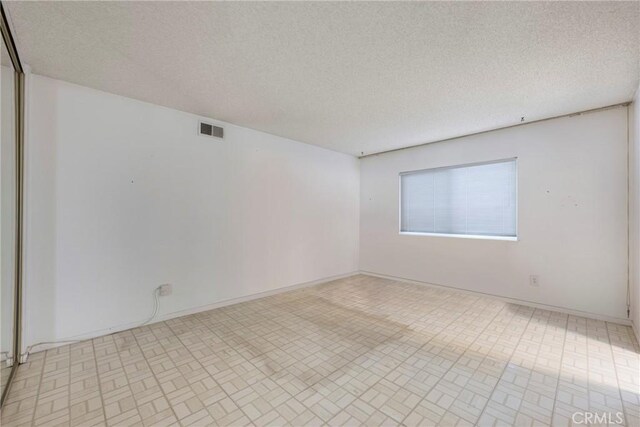 empty room with a textured ceiling