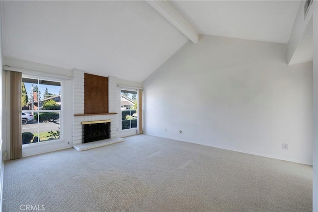 unfurnished living room featuring a brick fireplace, a wealth of natural light, light carpet, and beamed ceiling