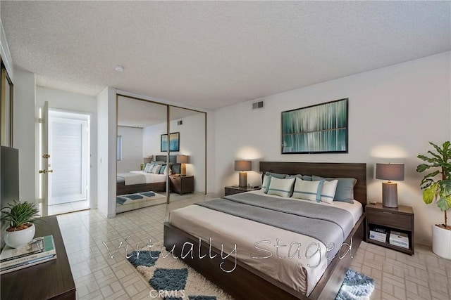 bedroom with a closet and a textured ceiling