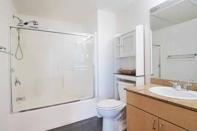 full bathroom featuring toilet, vanity, and bath / shower combo with glass door