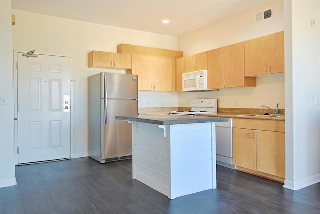 kitchen with a kitchen island, sink, light brown cabinets, and white appliances