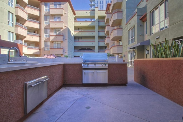 view of patio / terrace with an outdoor kitchen, sink, and grilling area