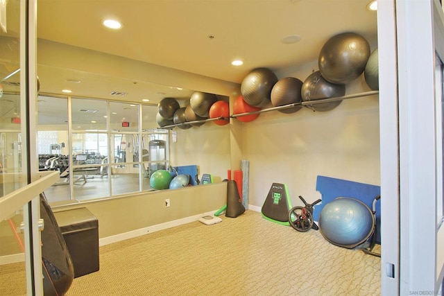 exercise room with light colored carpet