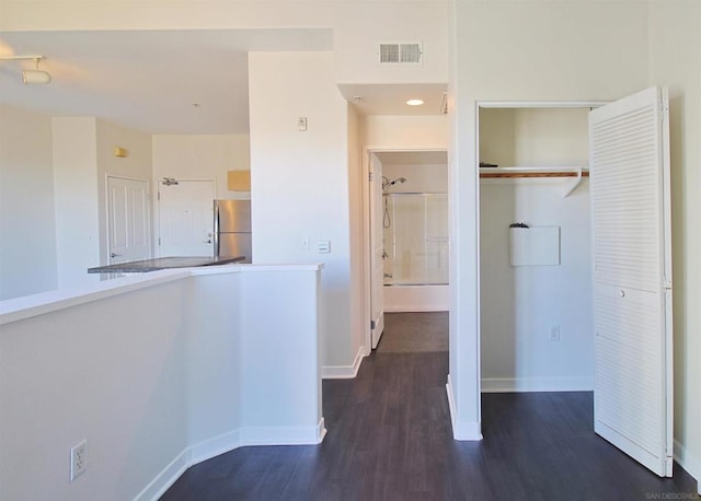 corridor with dark wood-type flooring