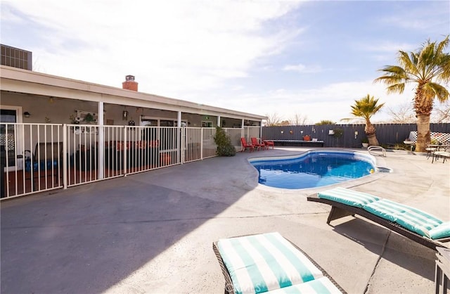 view of swimming pool with a patio