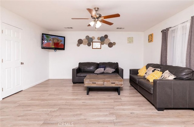 living room featuring ceiling fan and light hardwood / wood-style floors