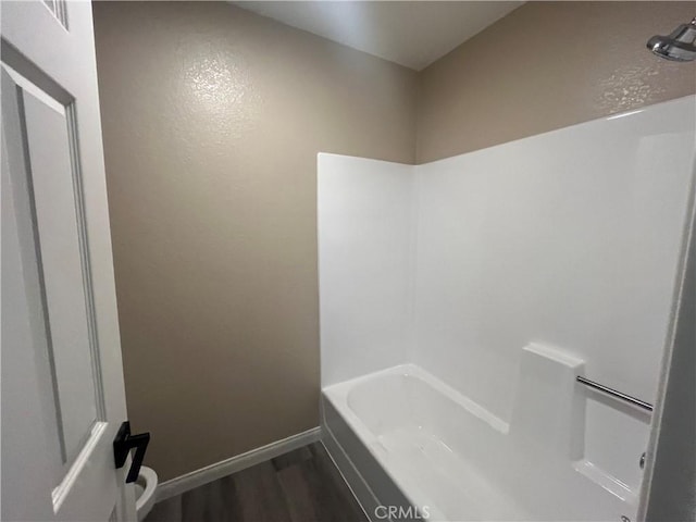 bathroom featuring hardwood / wood-style flooring and tub / shower combination