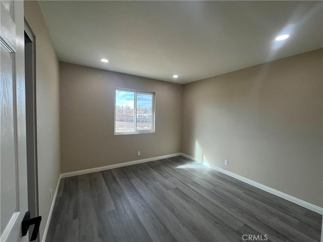 empty room with dark wood-type flooring