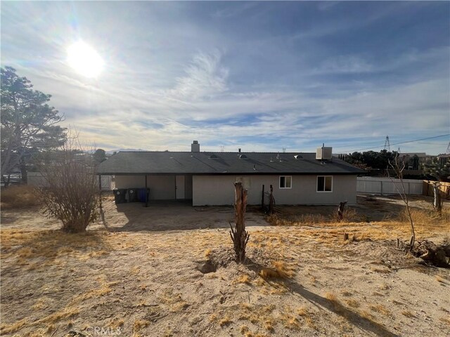 back of house featuring central AC unit