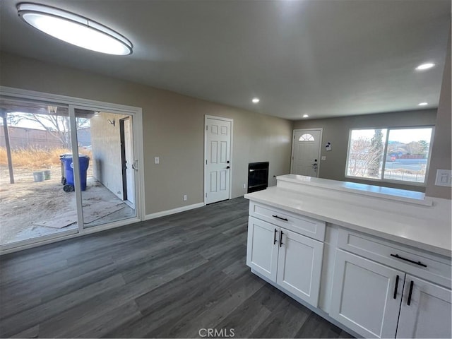 kitchen with dark wood-type flooring and white cabinetry