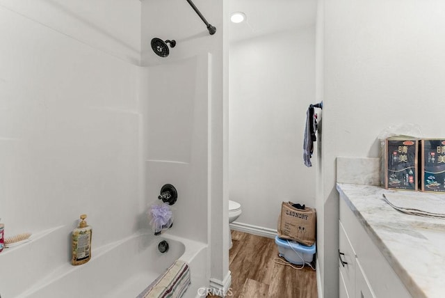 full bathroom featuring shower / washtub combination, toilet, vanity, and hardwood / wood-style flooring